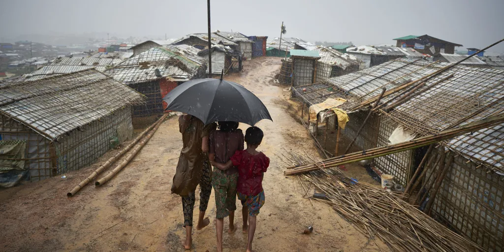Bangladesh. Rohingya Refugees Walk Through A Heavy Downpour Min