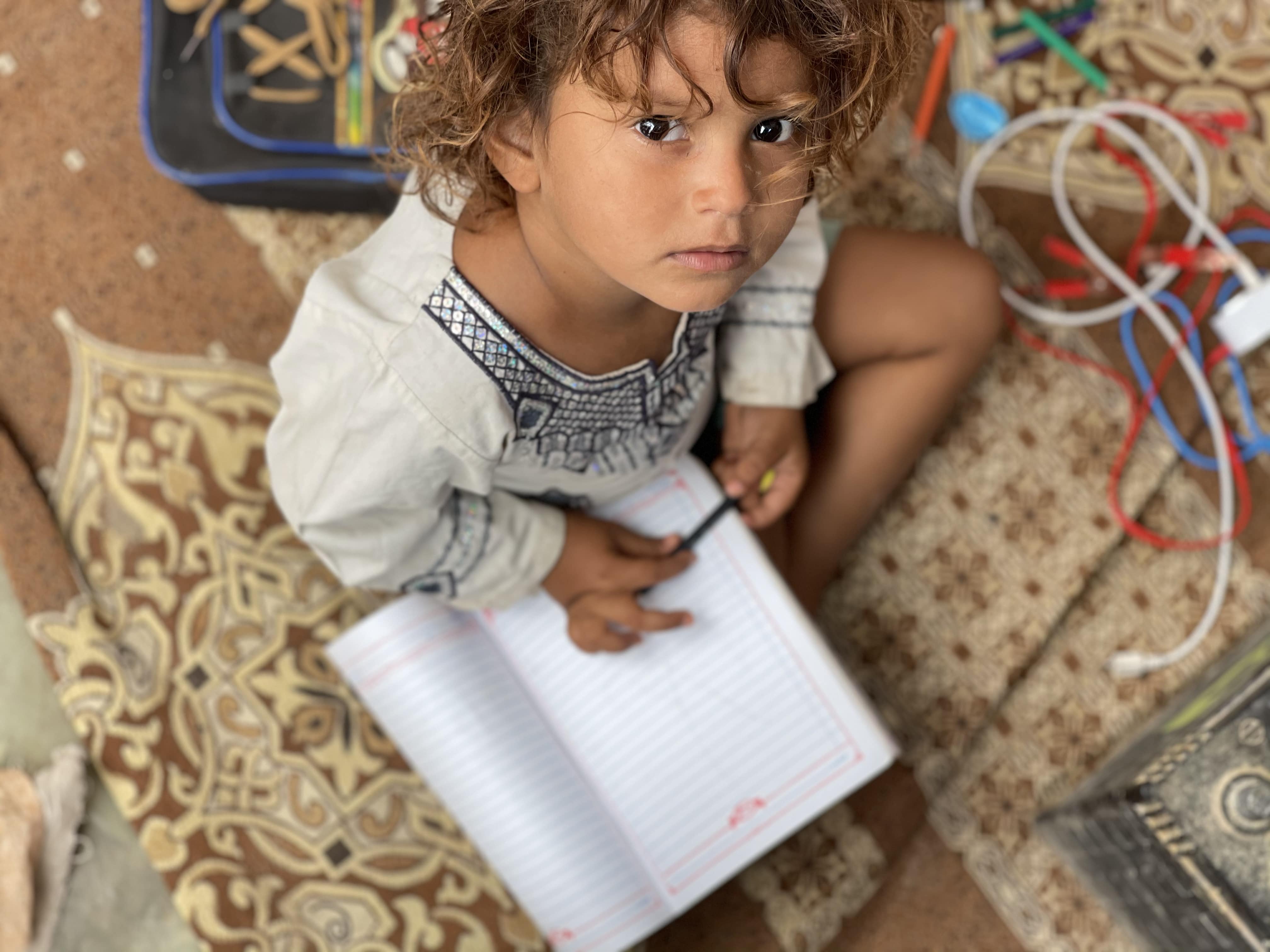 Tile Displaced Girl Practises Her Writing