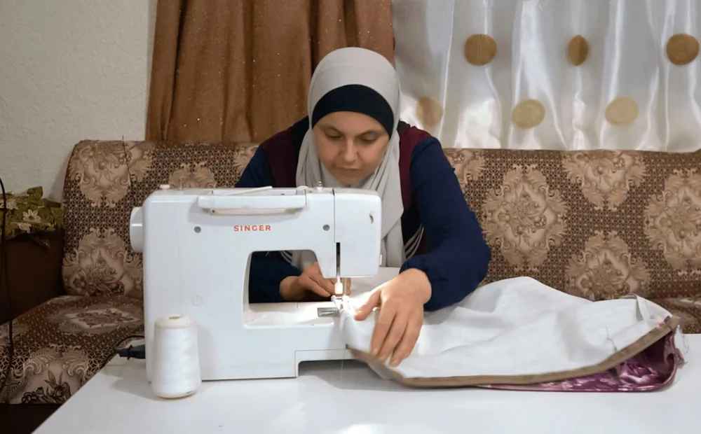 cta_jordan_woman-works-at-her-sewing-machine