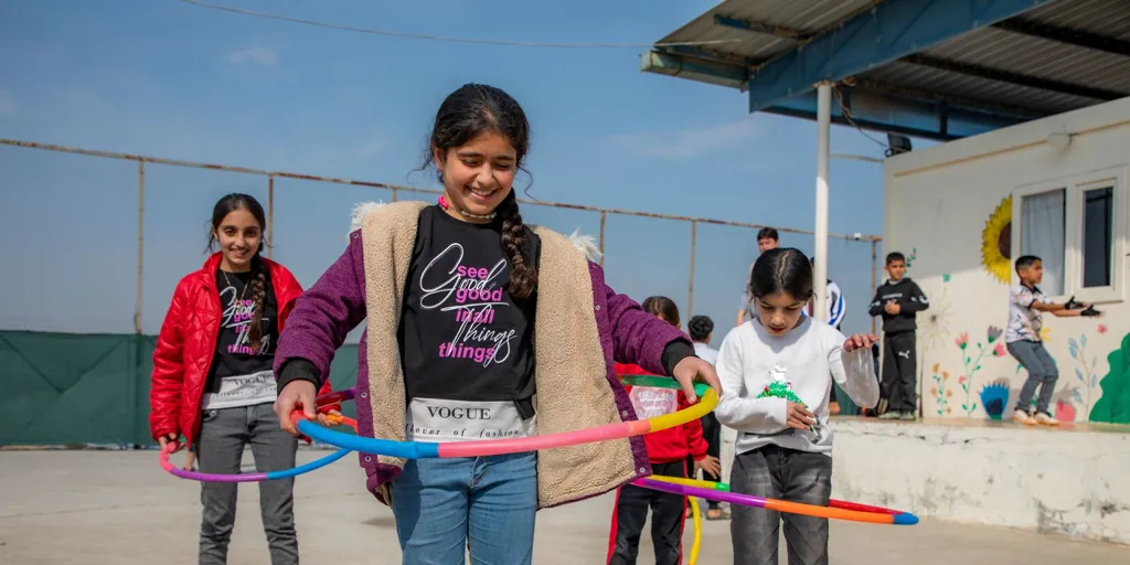 A group of Syrian refugee youth take part in sposts activities at UNHCR community centre in Darashakran camp in Erbil