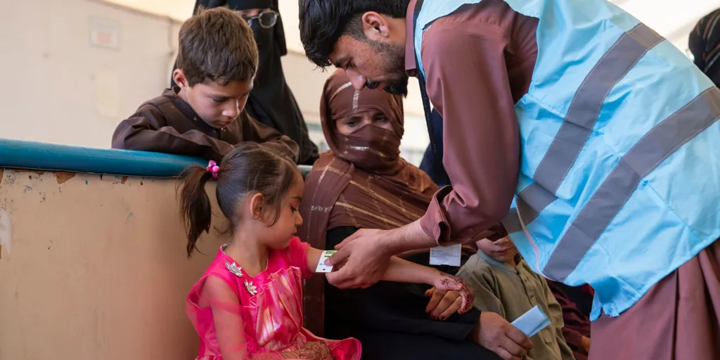Ayesha, 5, recently returned from Pakistan with his family. At the UNHCR Encashment Centre, he receives a health check-up and vaccination as part of the support provided to help families settle back into life in Afghanistan safely and healthily