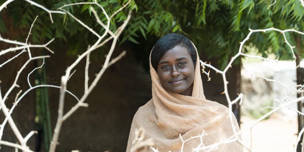 Islam, 21, was uprooted by conflict in Khartoum and now shelters at a refugee camp.