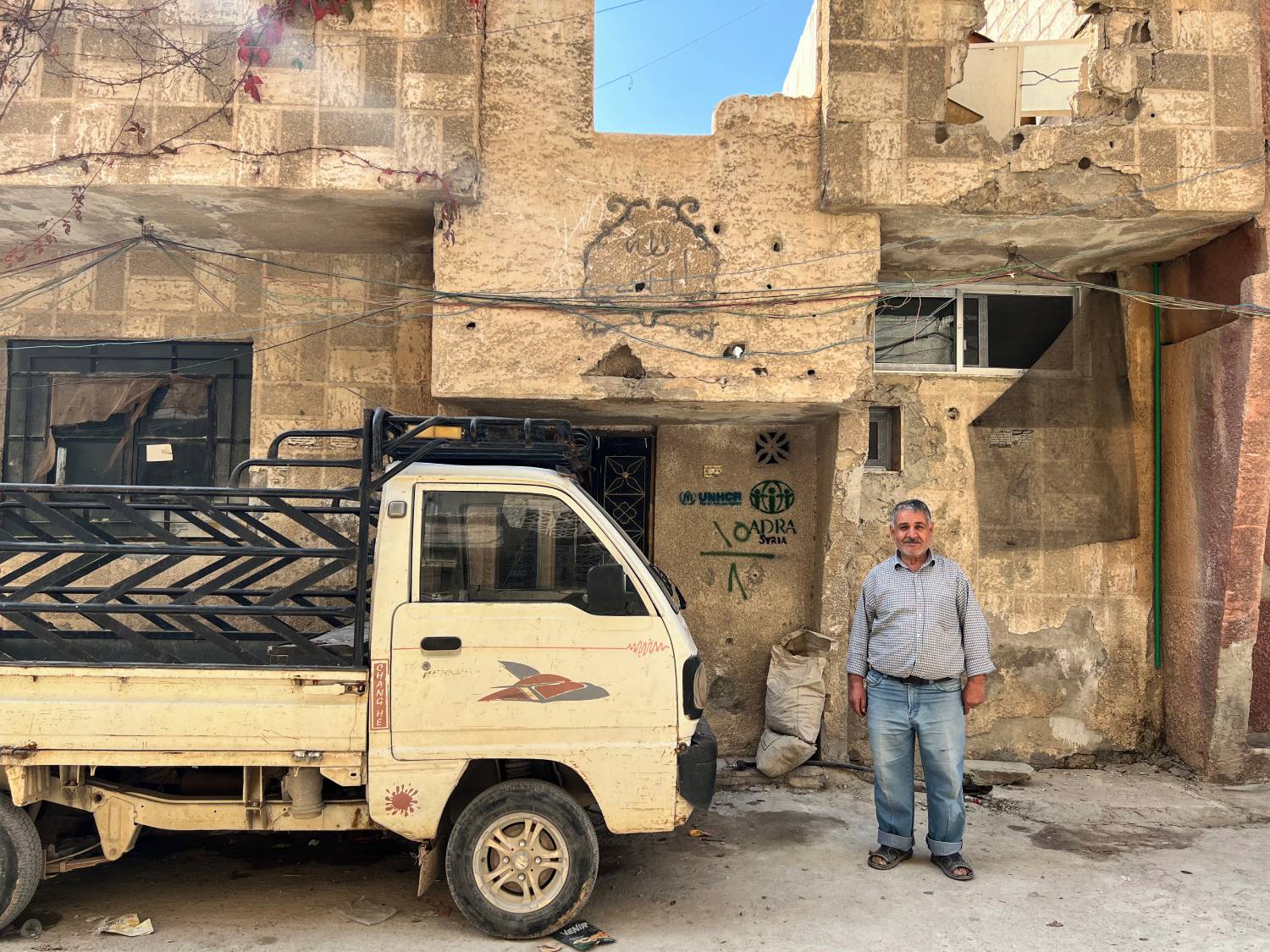 syria_khaled-stands-outside-his-repaired-home
