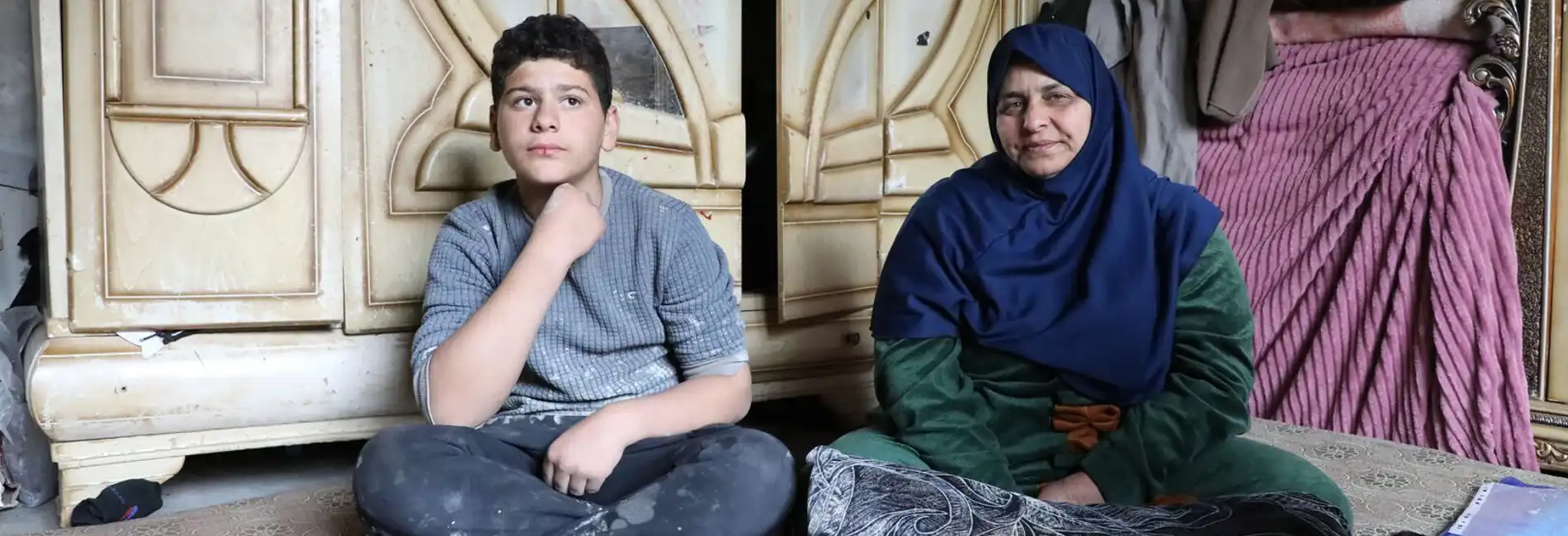 Syria_Ibtihal-and-her-youngest-son-Omar-in-their-damaged-home
